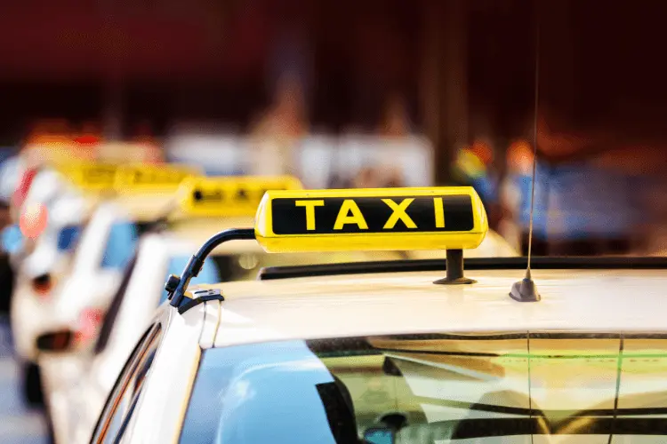 a car with a yellow board written as taxi