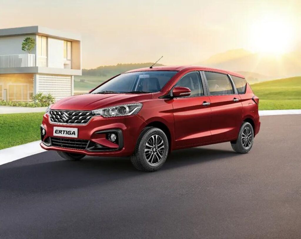 a red maruti ertiga car parked in a beautiful place in Trivandrum